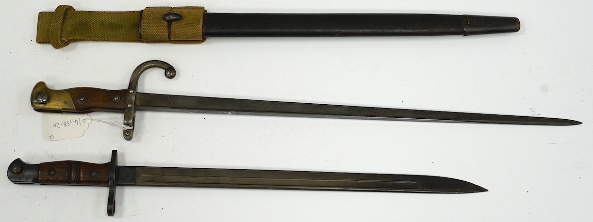 Two bayonets; a good Remington bayonet dated 1913 in its leather scabbard with khaki frog dated 1940, and a Gras bayonet dated 1880. Condition - good